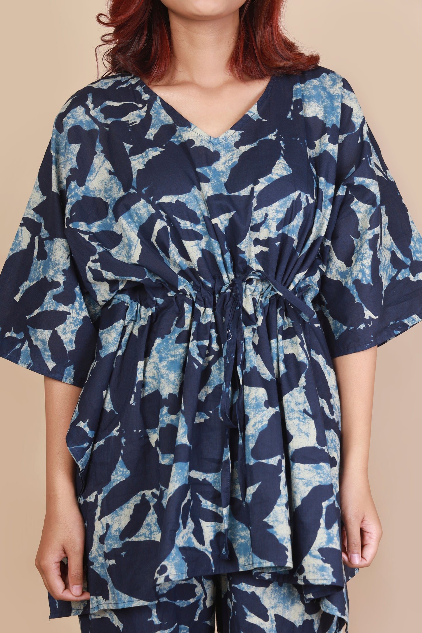 Navy blue and white floral patterned dress on a beige background