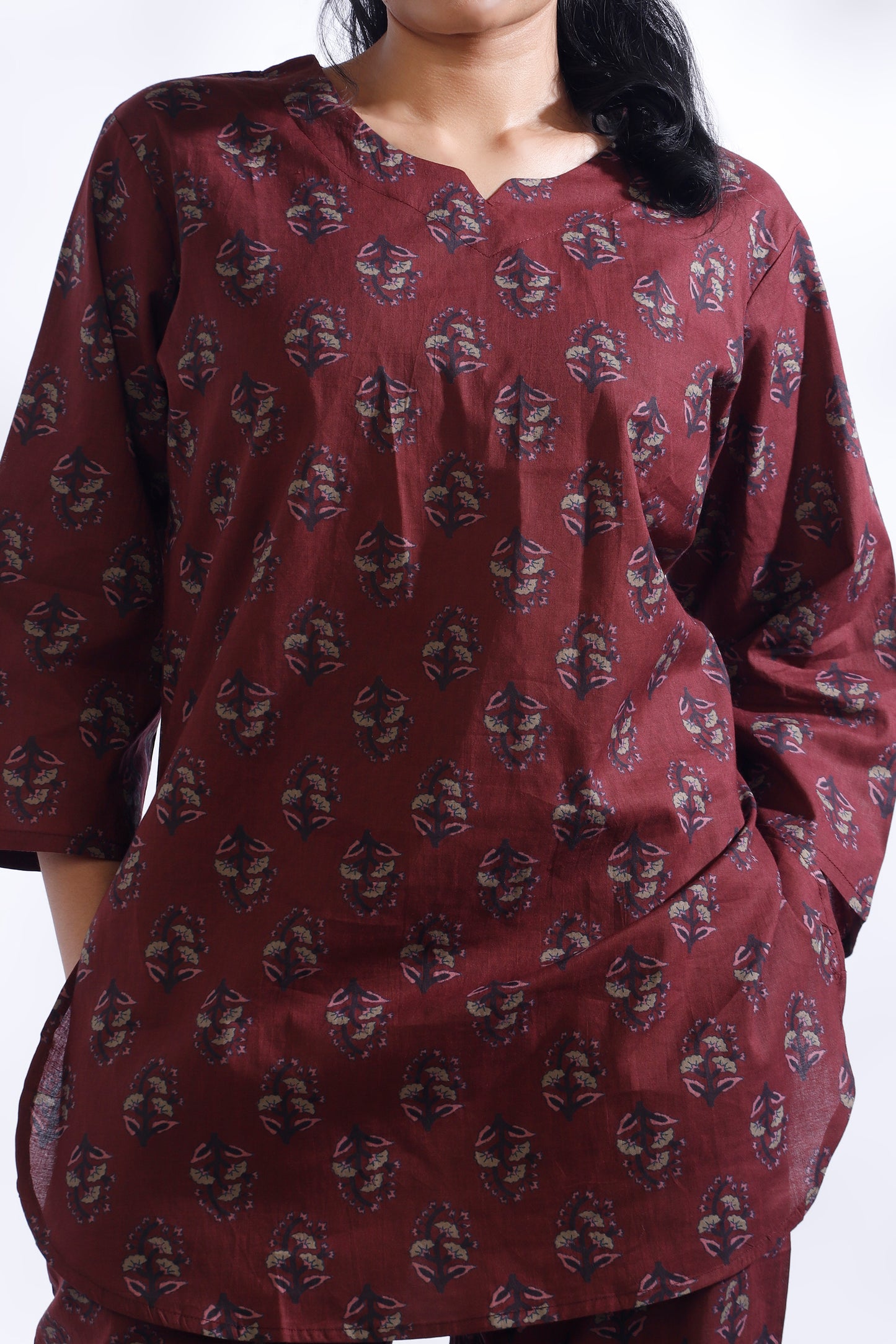 Maroon patterned kurta worn by a person on a white background