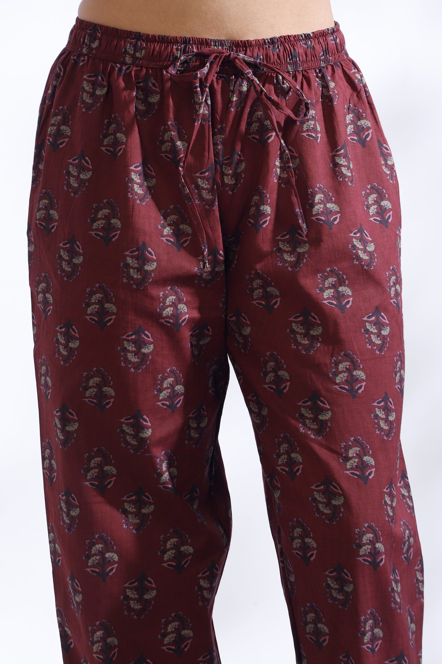 Maroon patterned pants on a white background