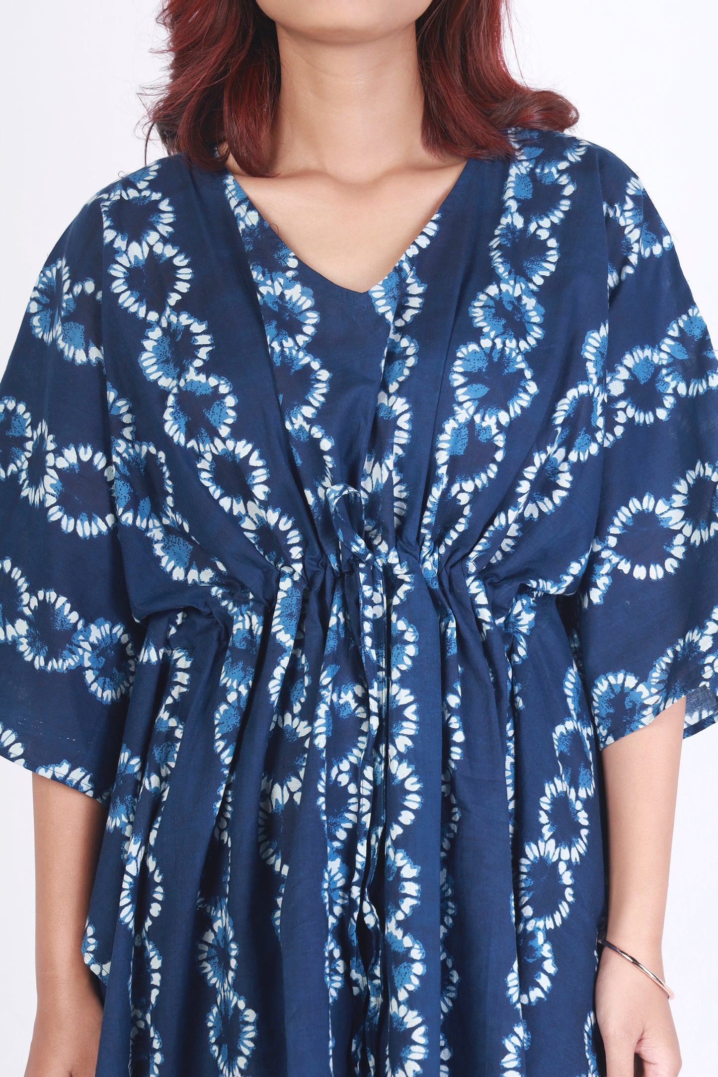 Navy blue dress with white floral pattern worn by a person