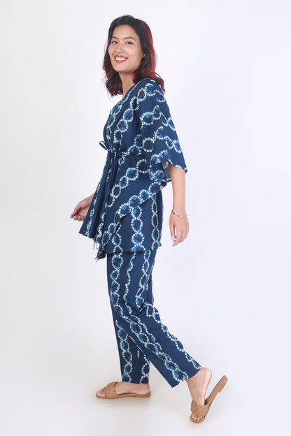 Woman wearing a blue patterned outfit on a white background