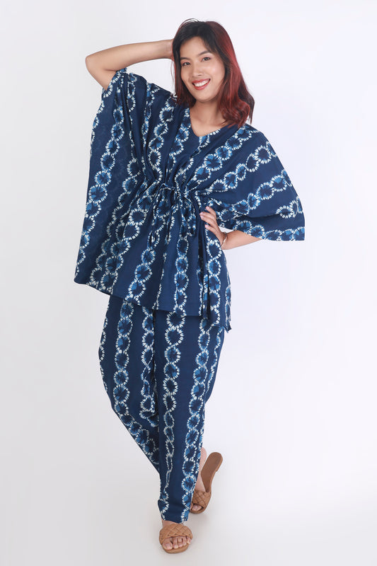 Woman wearing a blue patterned outfit on a white background