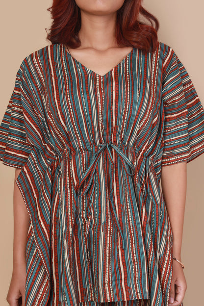 Multicolored striped dress worn by a person on a beige background