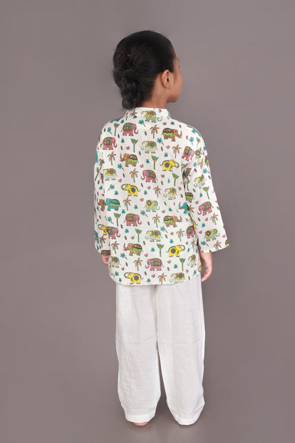 Child wearing a colorful elephant animal patterned Kurta and white pants 
