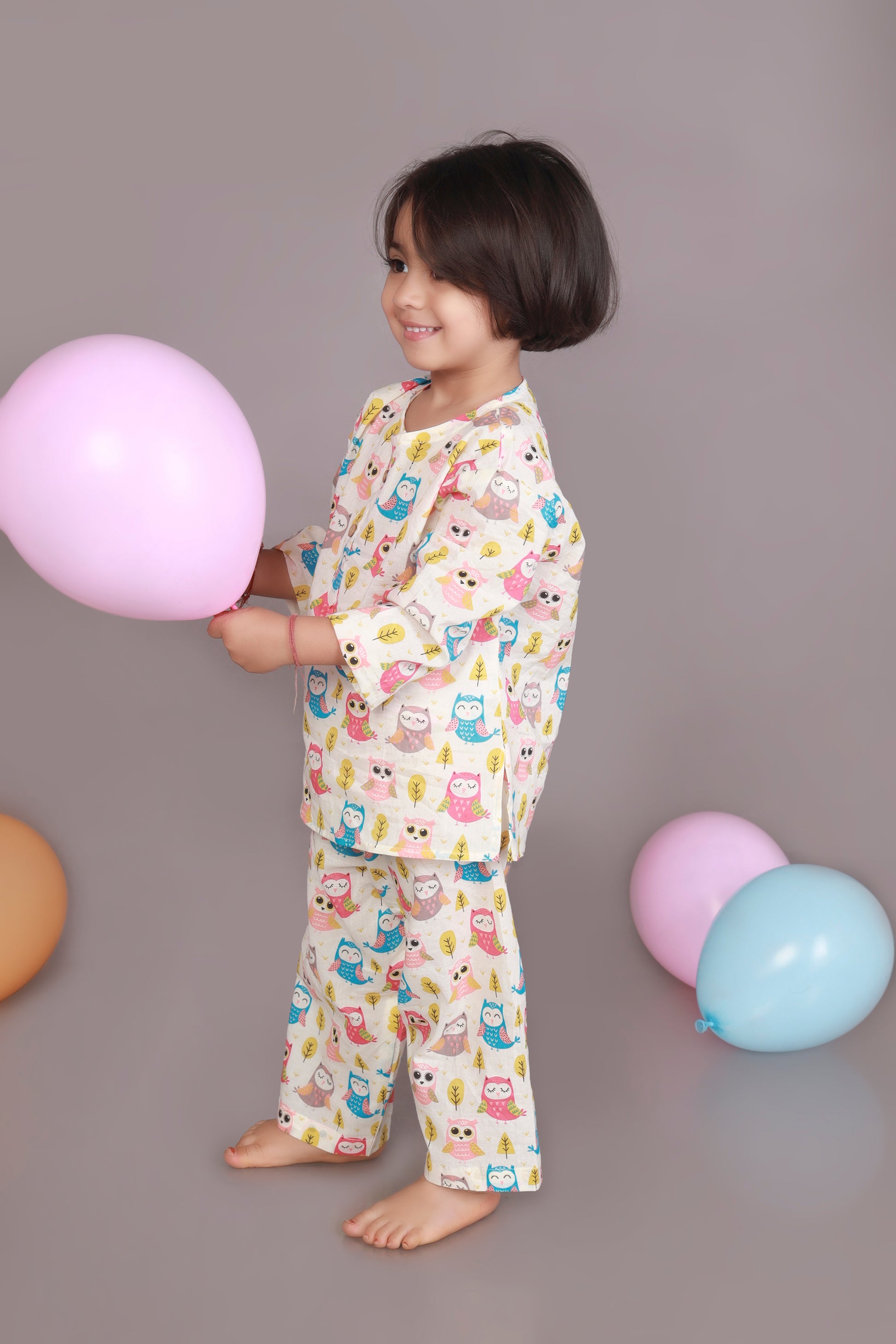 Child wearing a colorful owl patterned kurta pajama set 