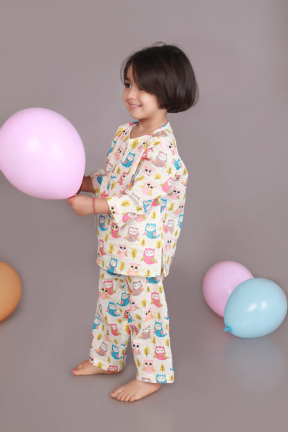 Child wearing a colorful owl patterned kurta pajama set 