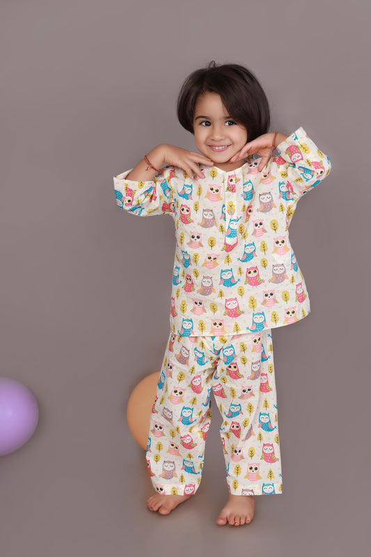 Child wearing a colorful owl patterned kurta pajama set 