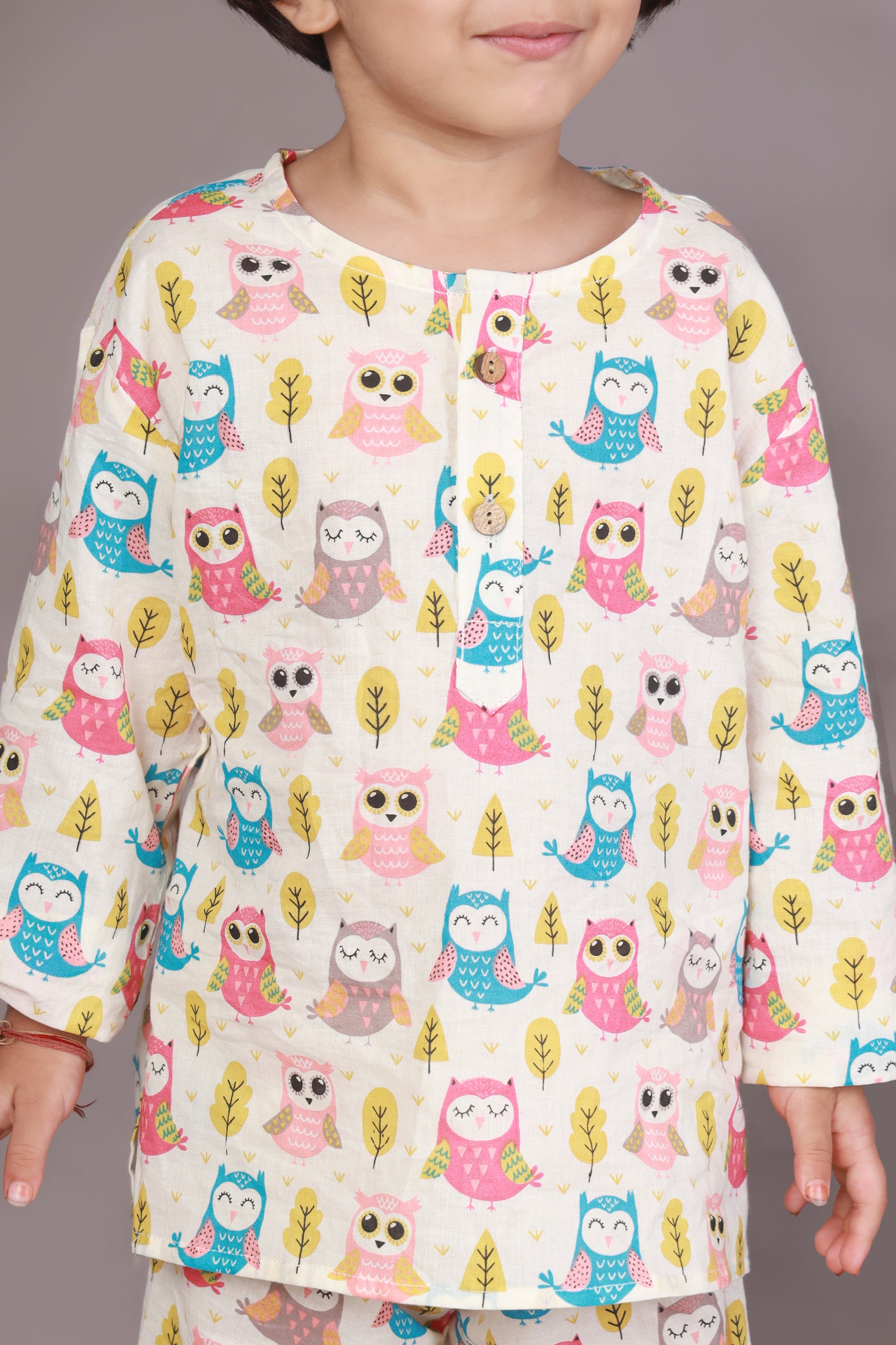 Child wearing a colorful owl patterned kurta pajama set 