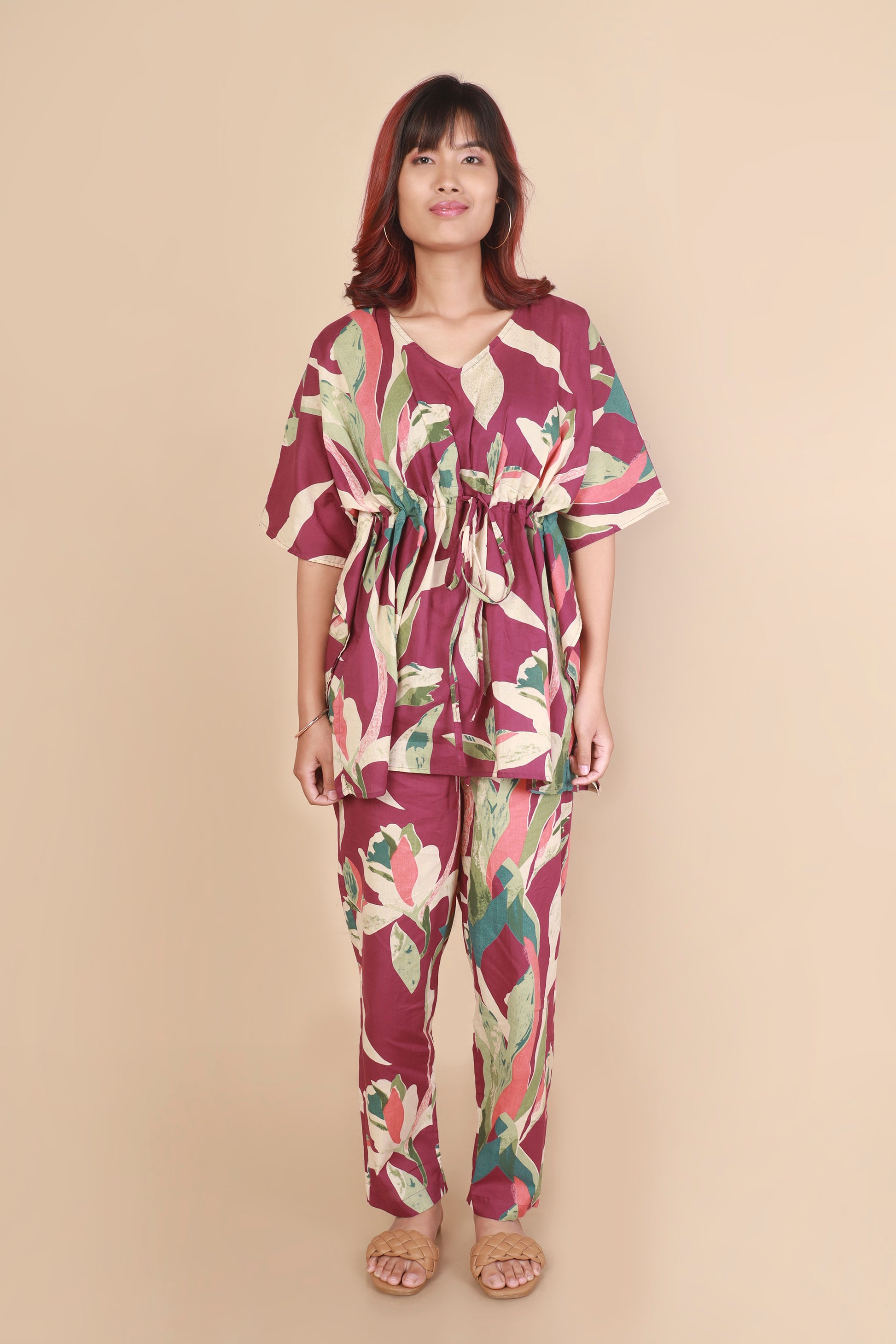 Woman wearing a floral outfit on a beige background