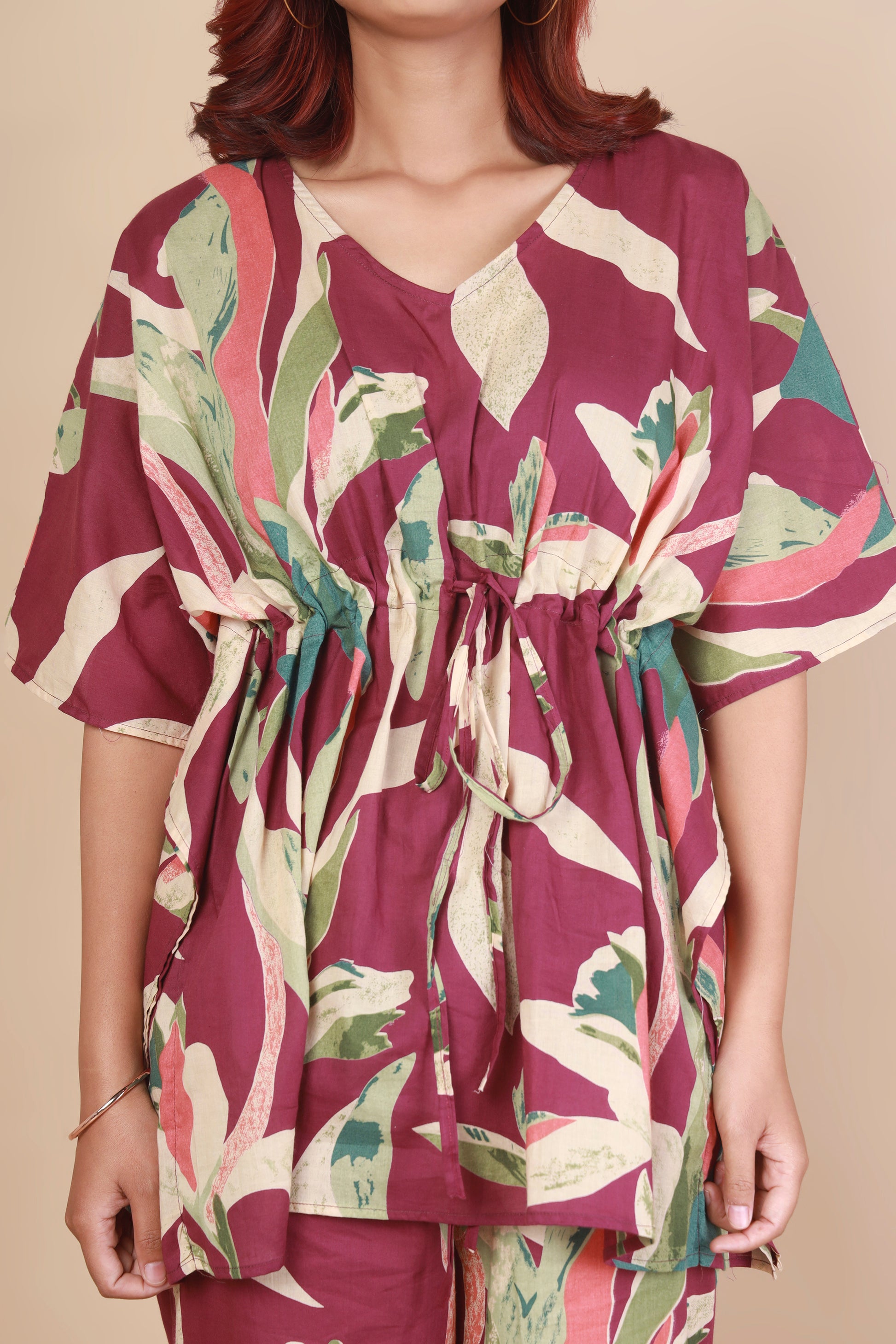 Woman wearing a floral dress with a neutral background