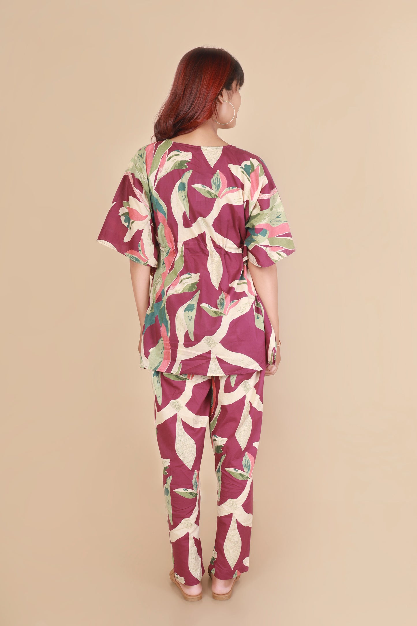 Woman wearing a floral outfit on a beige background