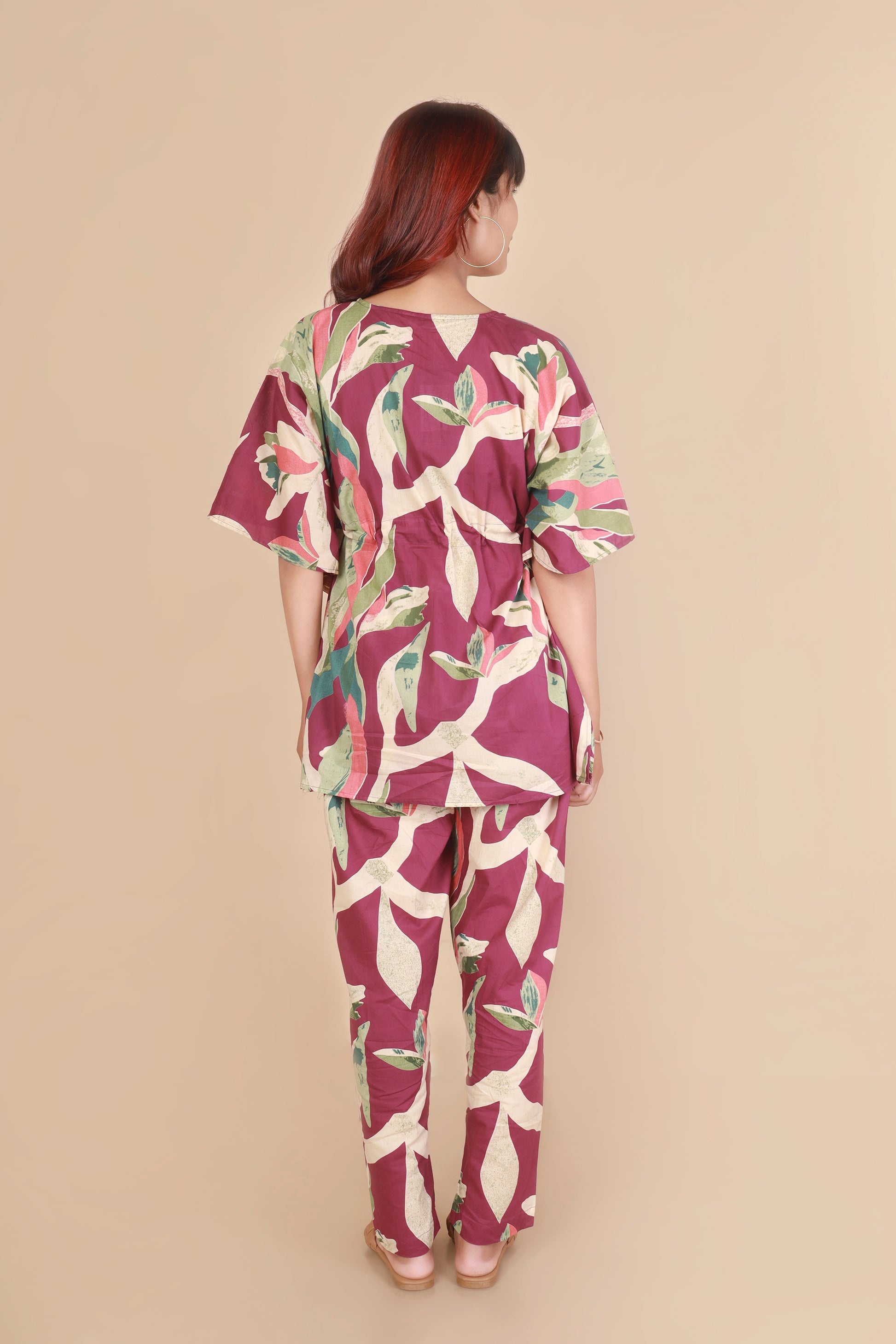 Woman wearing a floral outfit on a beige background