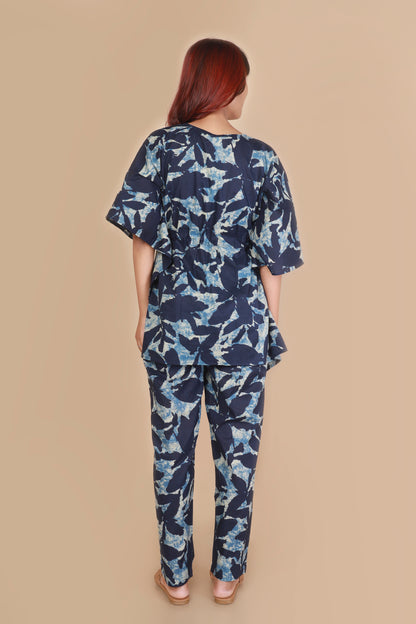 Woman wearing a blue floral outfit on a beige background