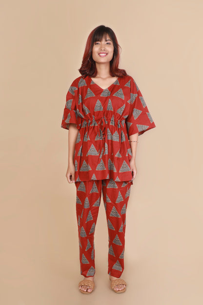 Woman wearing a red and gray patterned outfit on a beige background