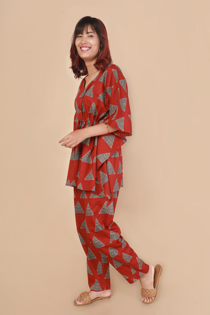 Woman wearing a red patterned outfit on a beige background