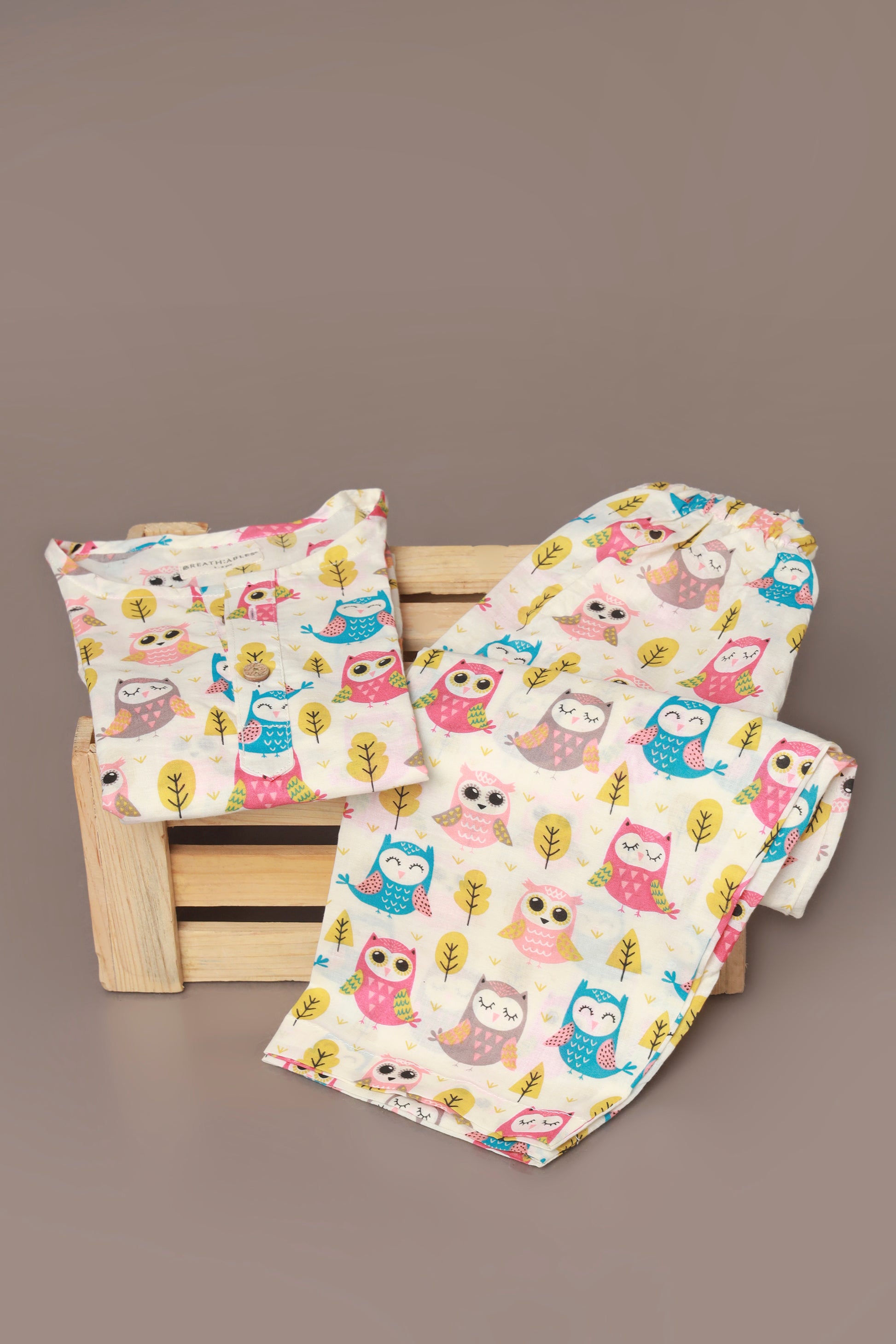 Child wearing a colorful owl patterned kurta pajama set 