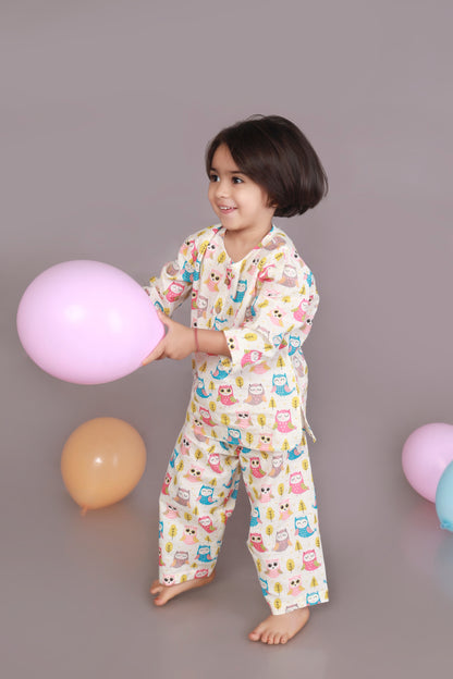 Child wearing a colorful owl patterned kurta pajama set 