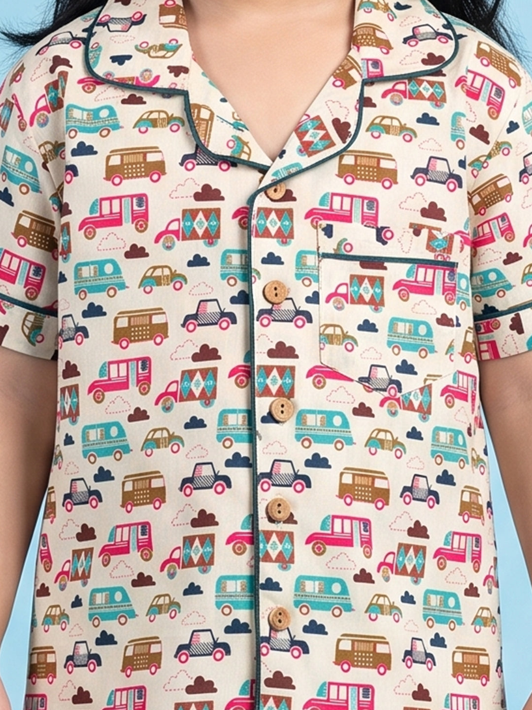 Kids pajama nightsuit with bus and car print close up 