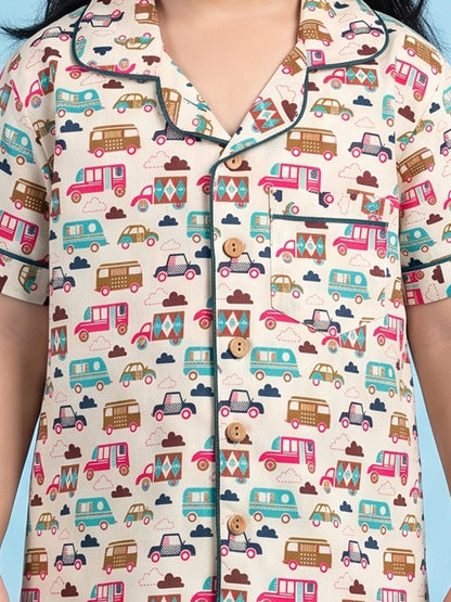 Kids pajama nightsuit with bus and car print close up 