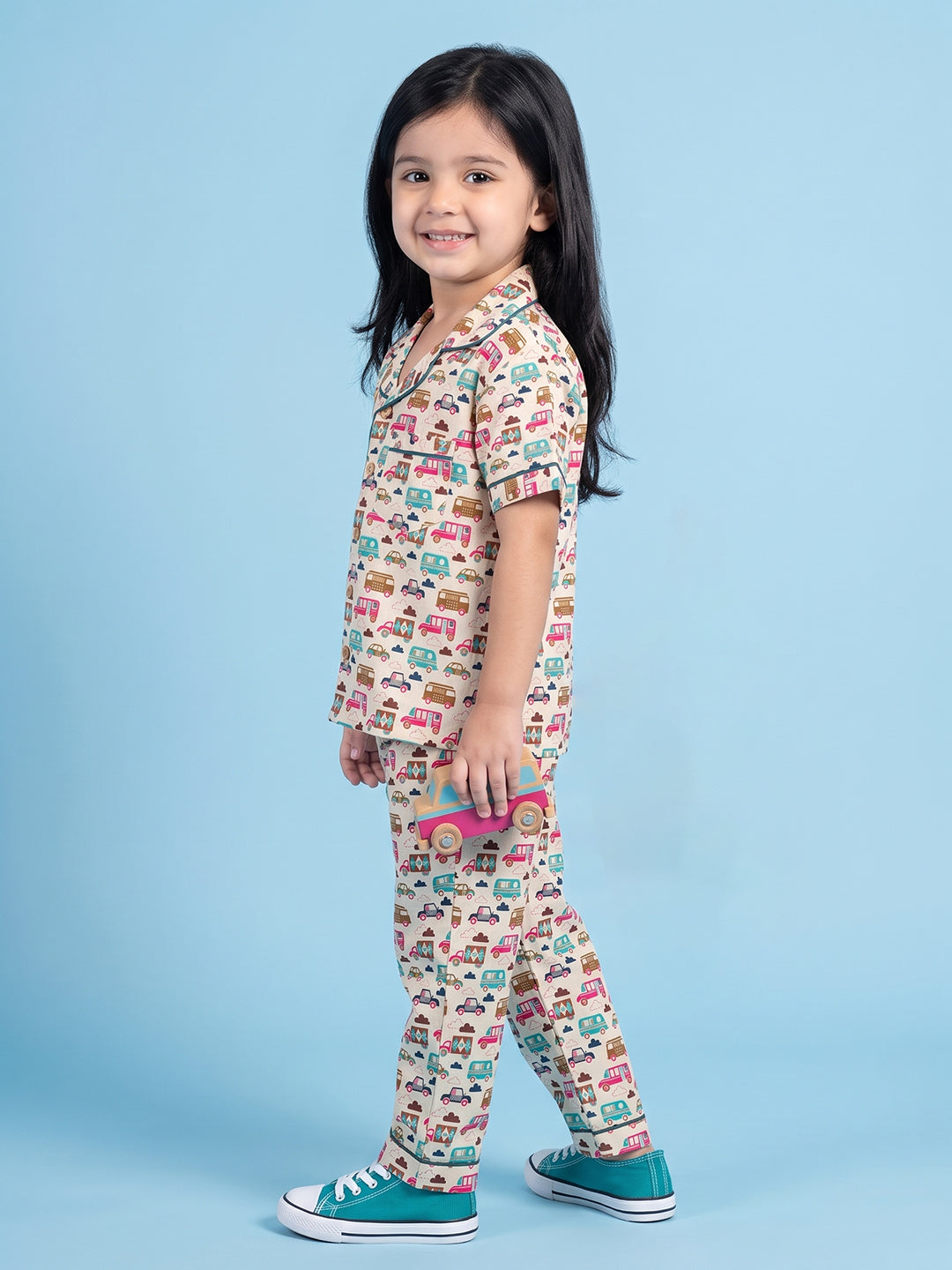 Kids pajama nightsuit with bus and car print standing side 
