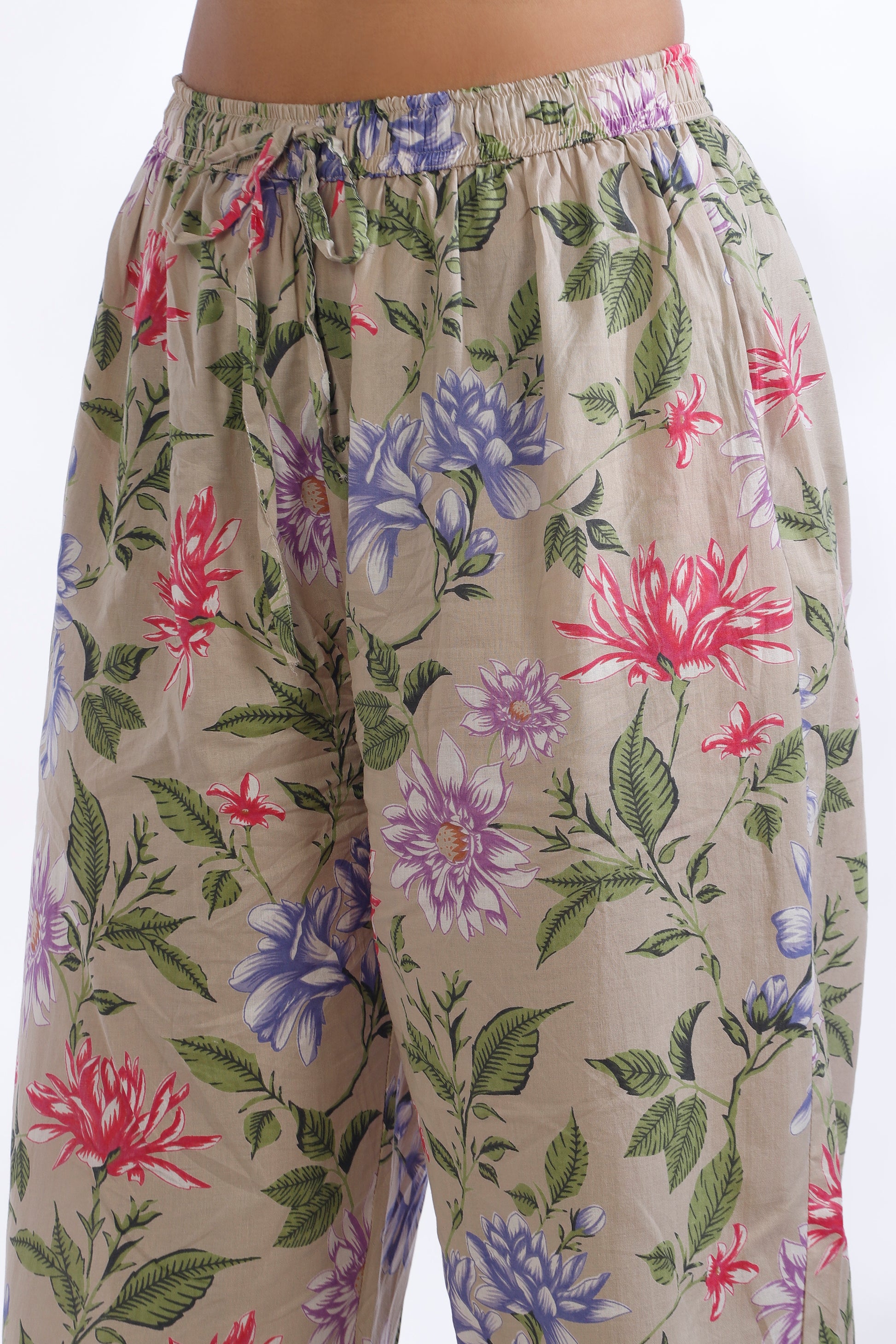 Floral patterned pants on a beige background