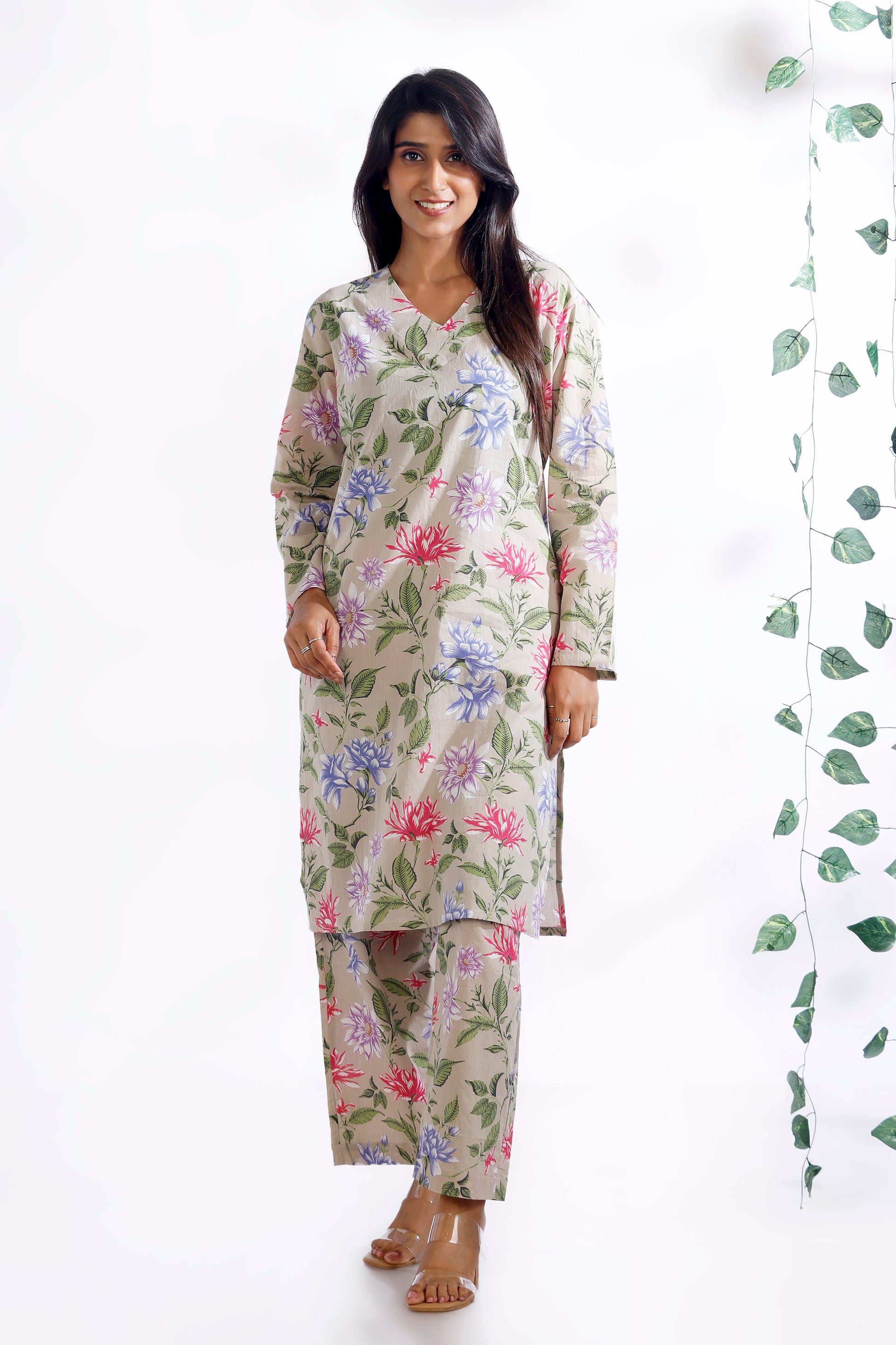 Woman wearing a floral nightgown with a white background