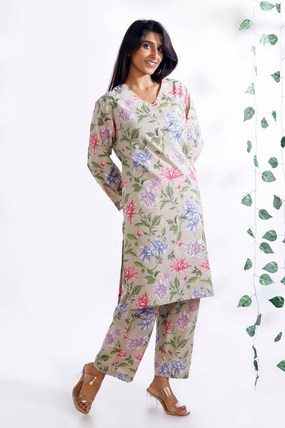 Woman wearing a floral kurta with pants on a white background