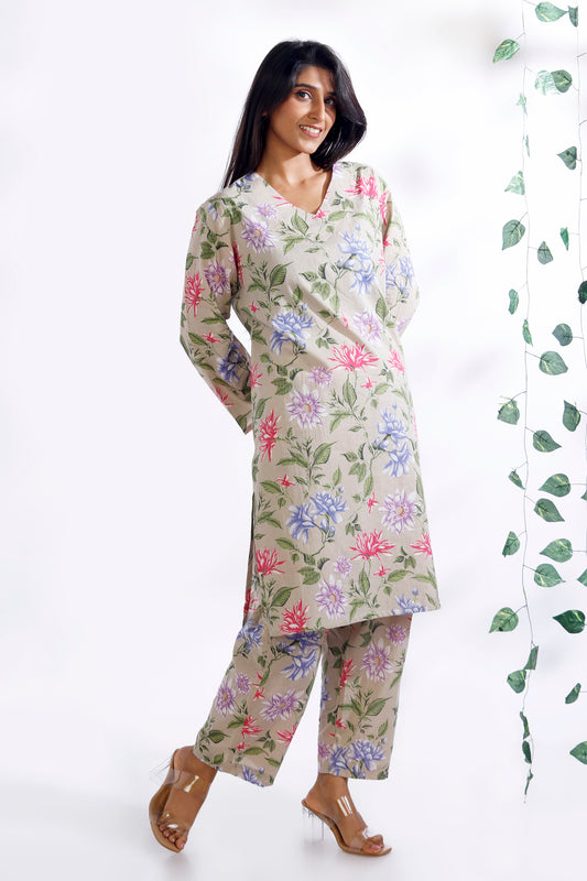 Woman wearing a floral kurta with pants on a white background