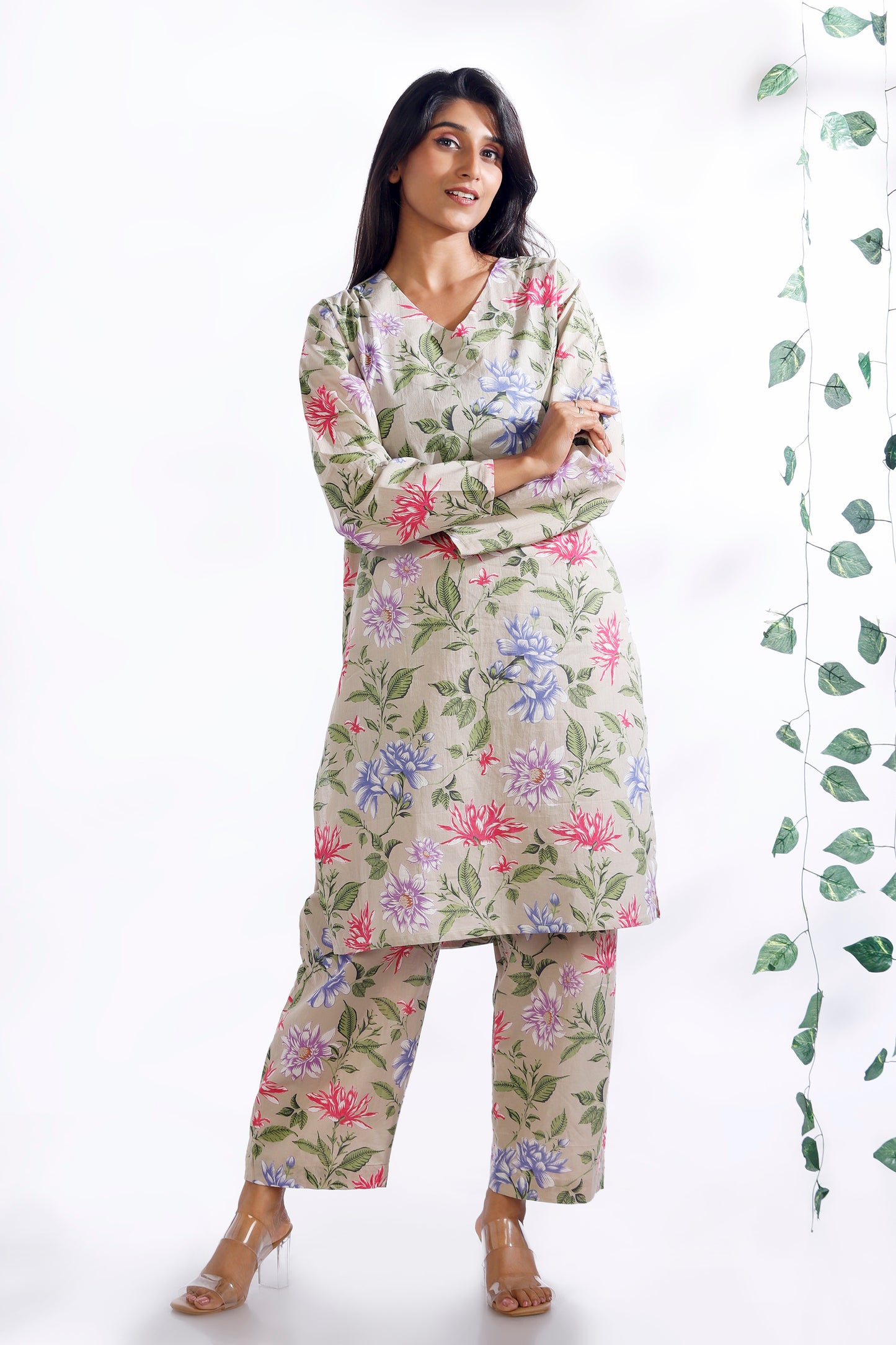 Woman wearing a floral outfit with a white background