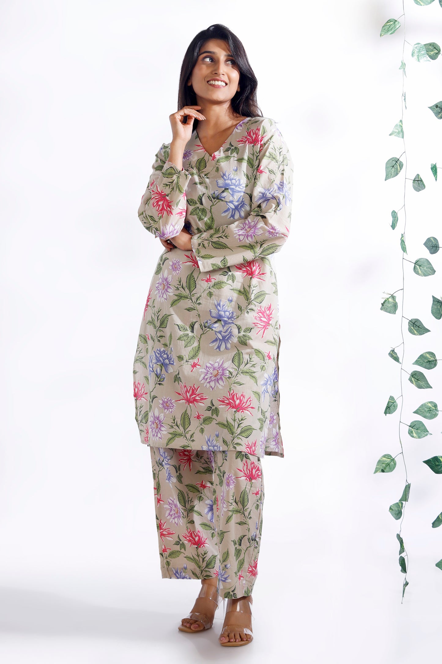 Woman wearing a floral nightgown with a white background