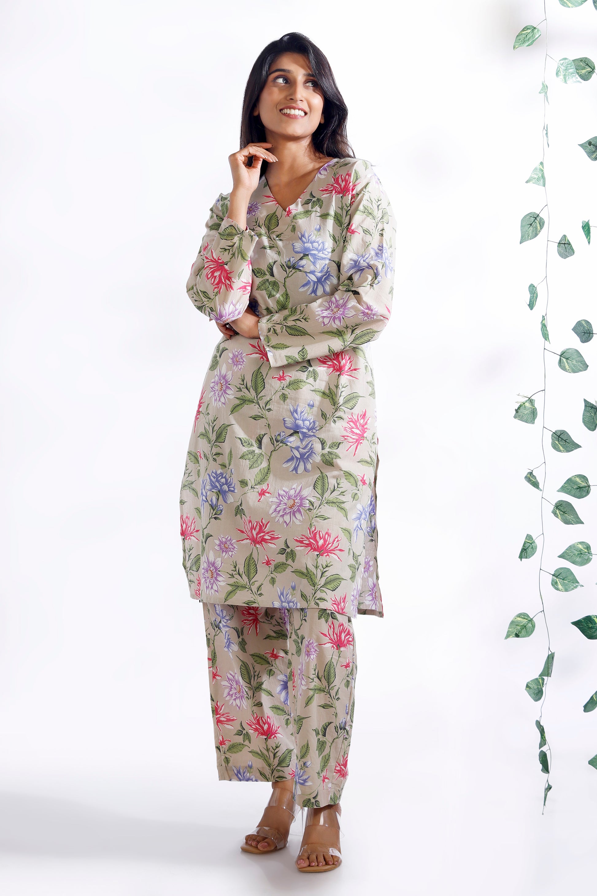 Woman wearing a floral nightgown with a white background