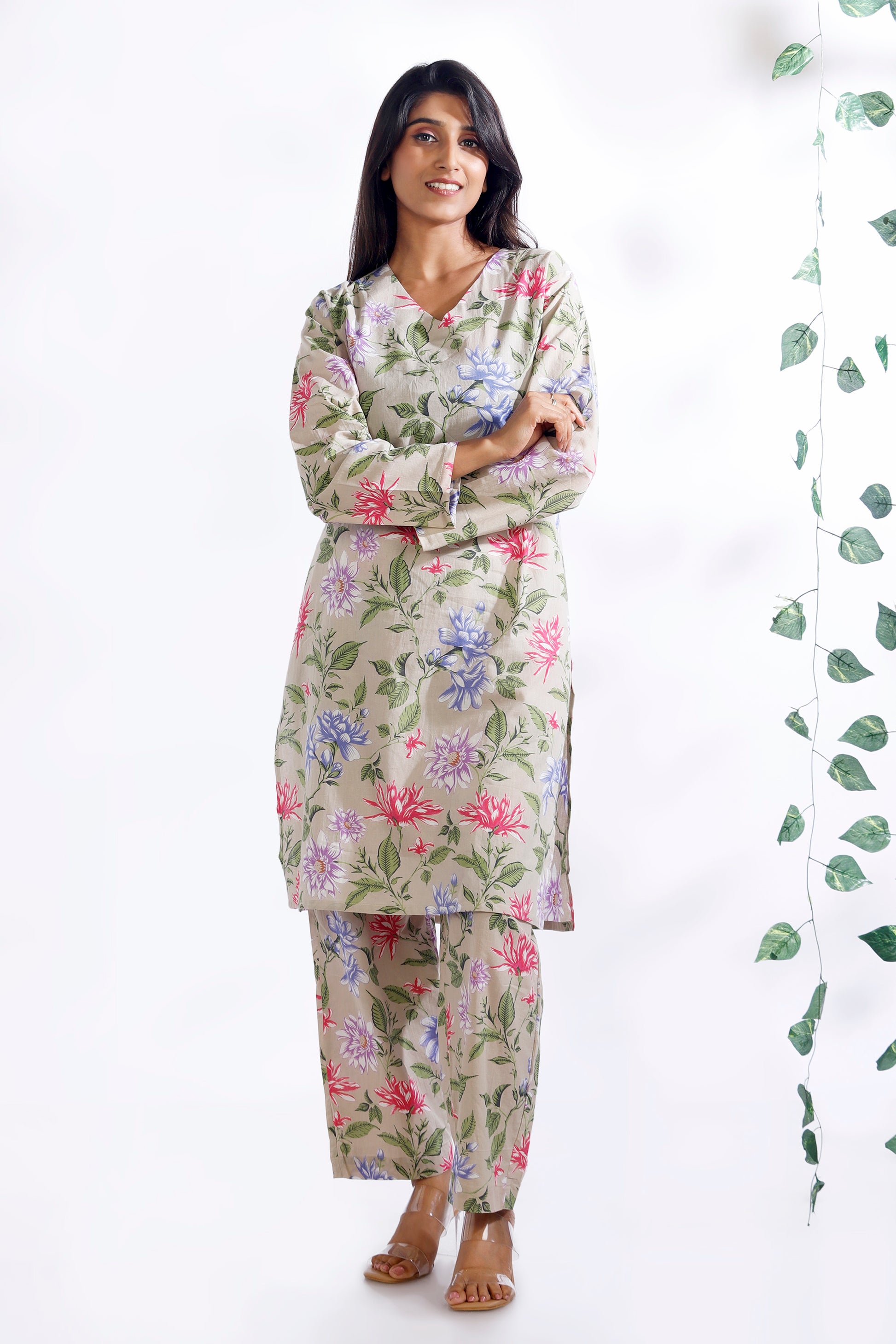 Woman wearing a floral pajama set on a white background