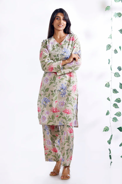 Woman wearing a floral pajama set on a white background