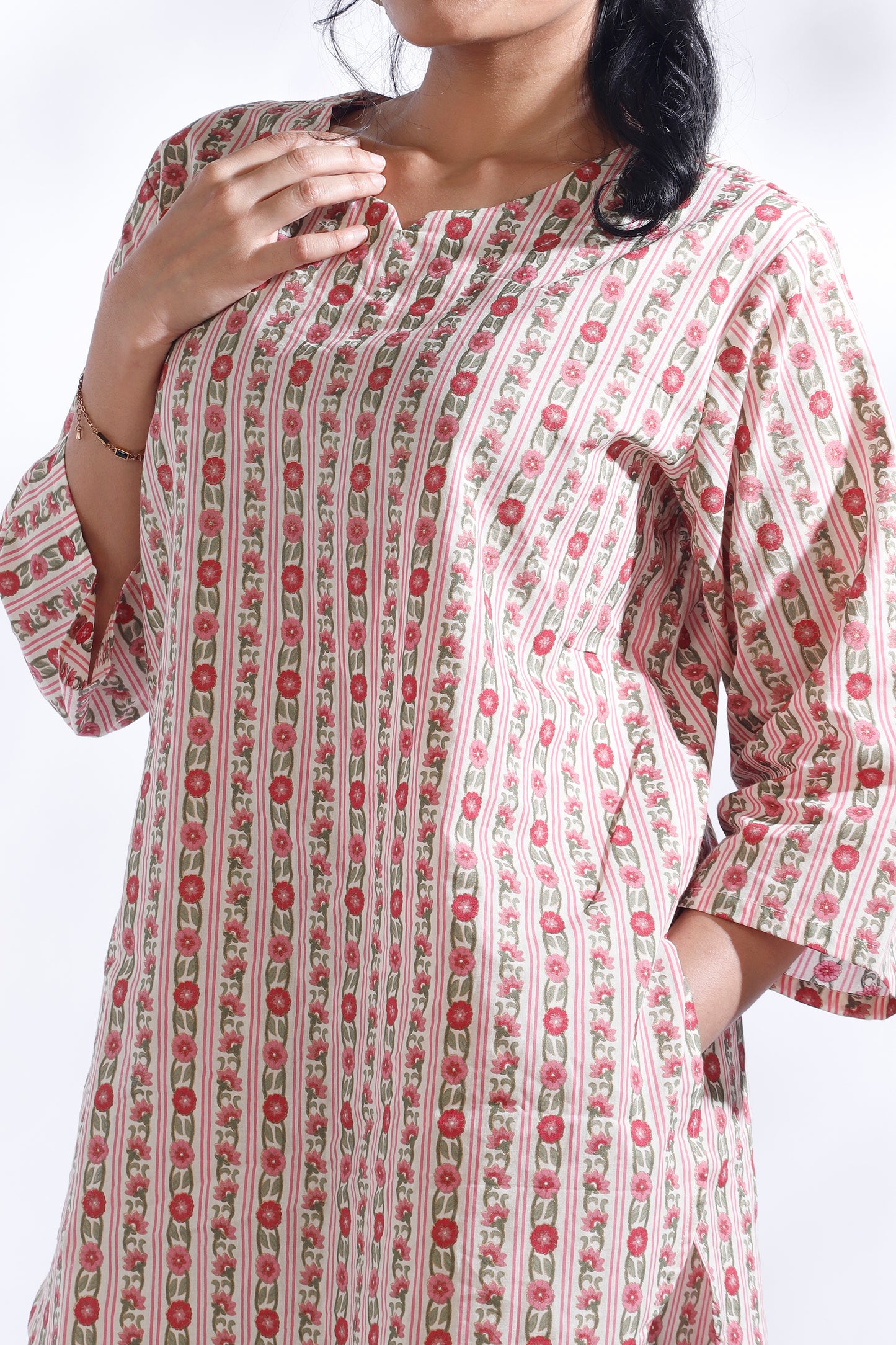 Woman wearing a patterned dress with a white background