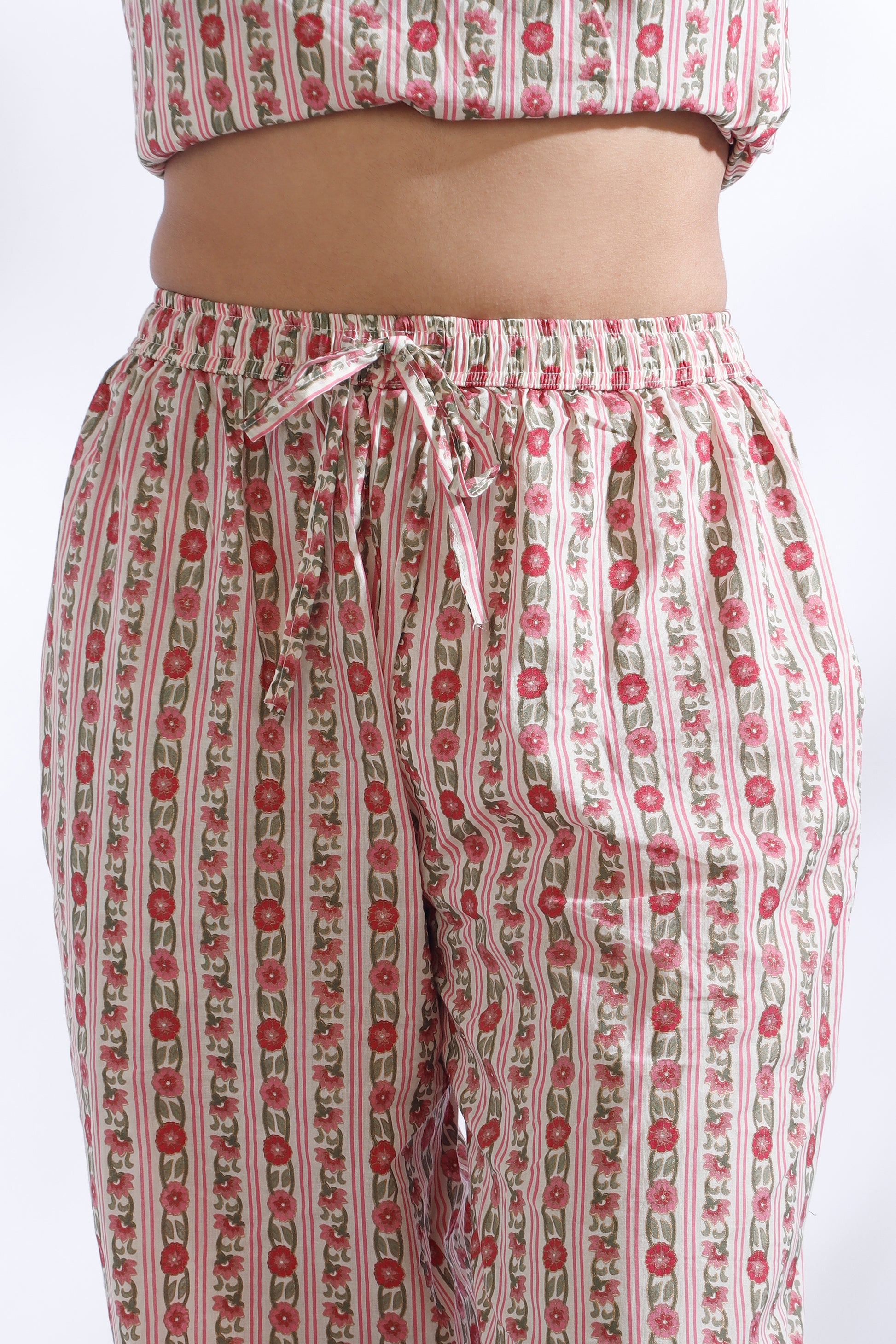 Floral patterned pants with a matching top on a white background