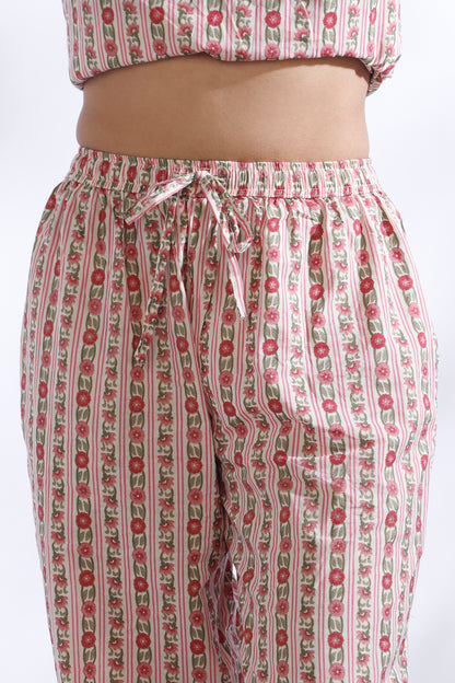 Floral patterned pants with a matching top on a white background