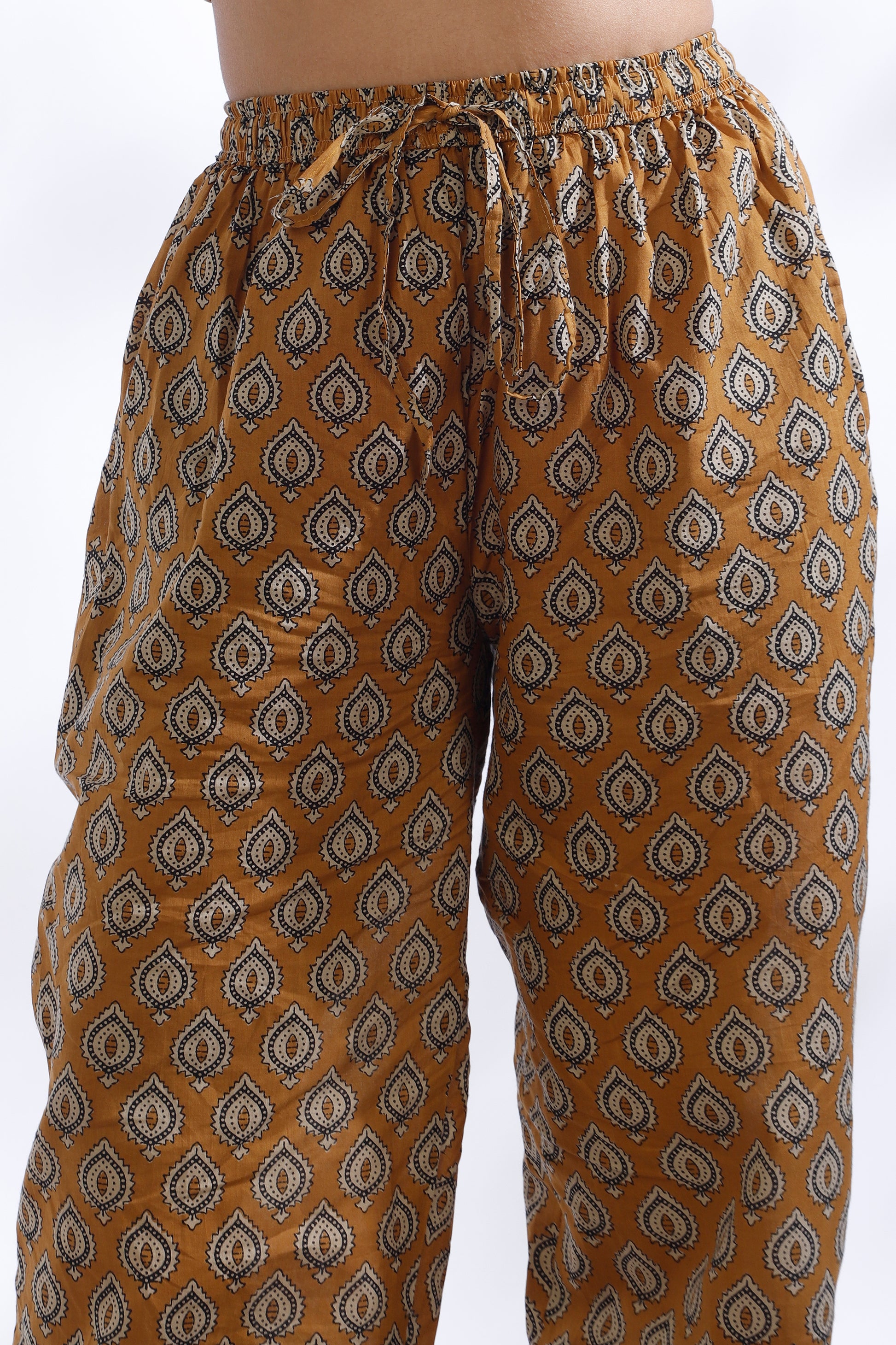 Brown patterned pants on a white background