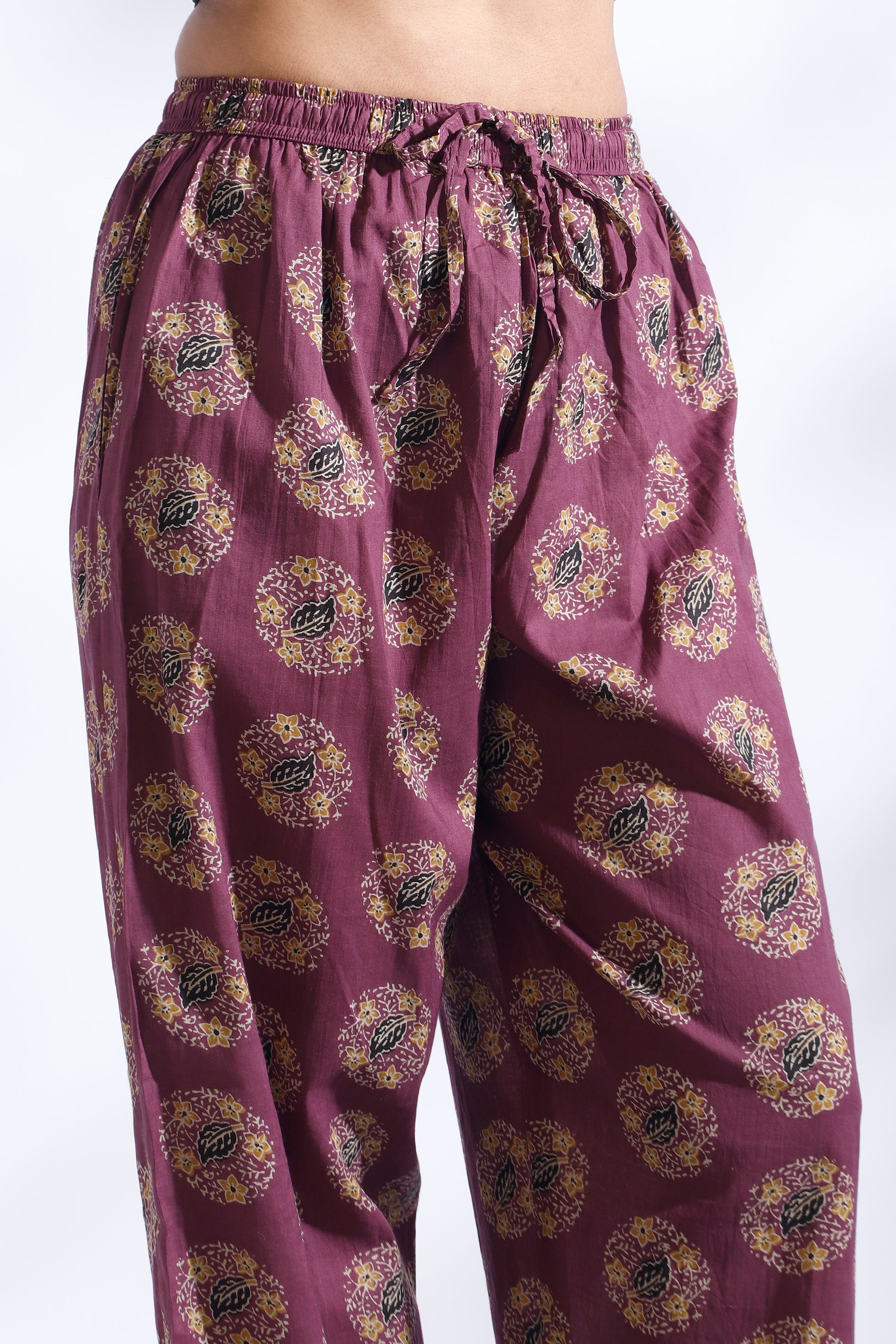 Purple patterned pants on a white background