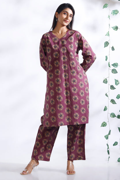 Woman wearing a purple floral outfit with a white background
