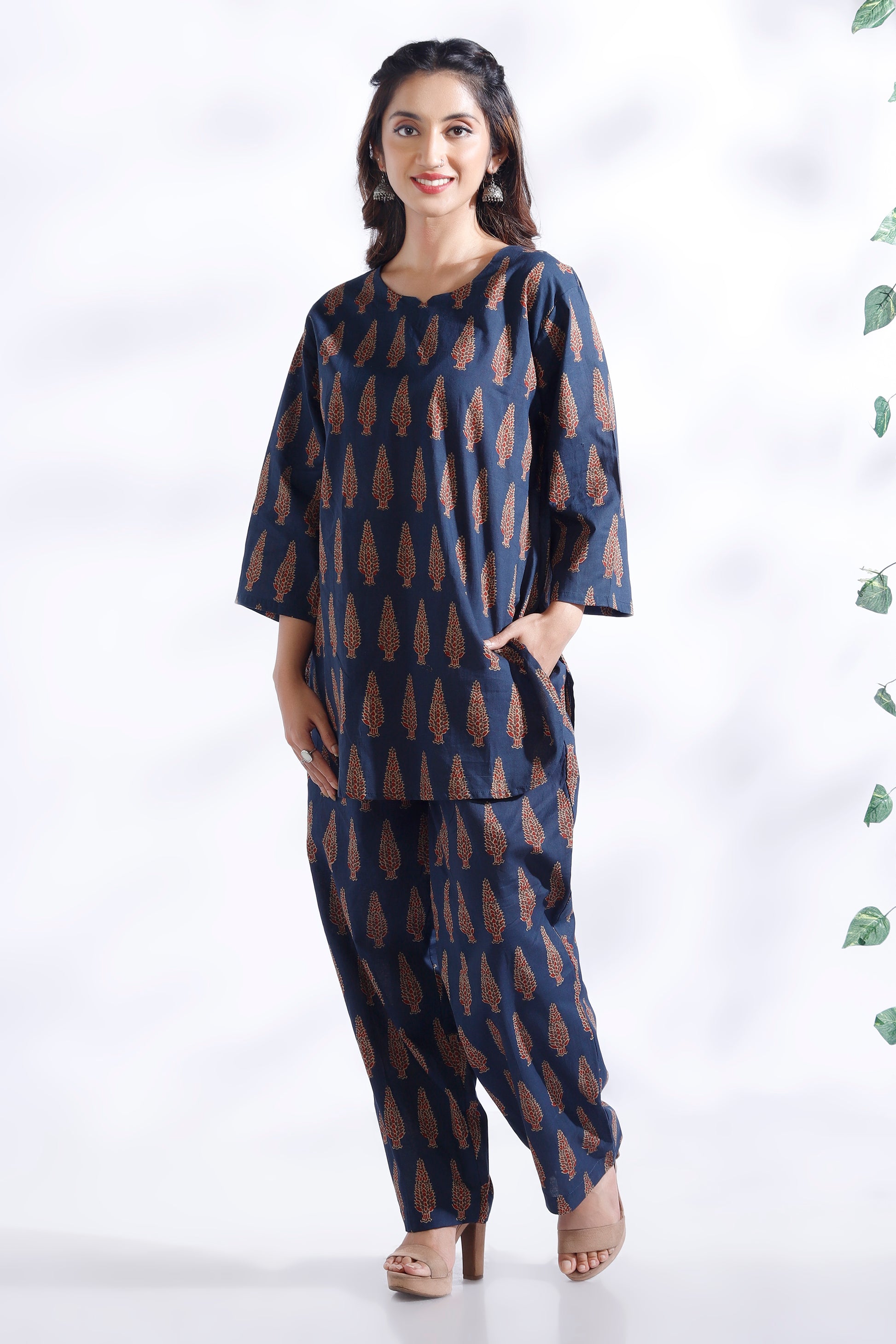Woman wearing a blue patterned outfit on a white background