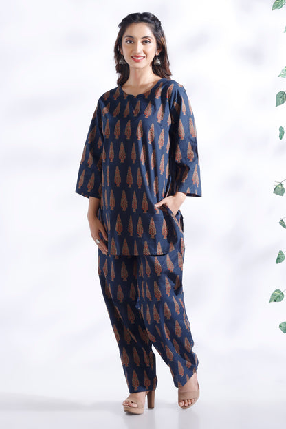 Woman wearing a blue patterned outfit on a white background