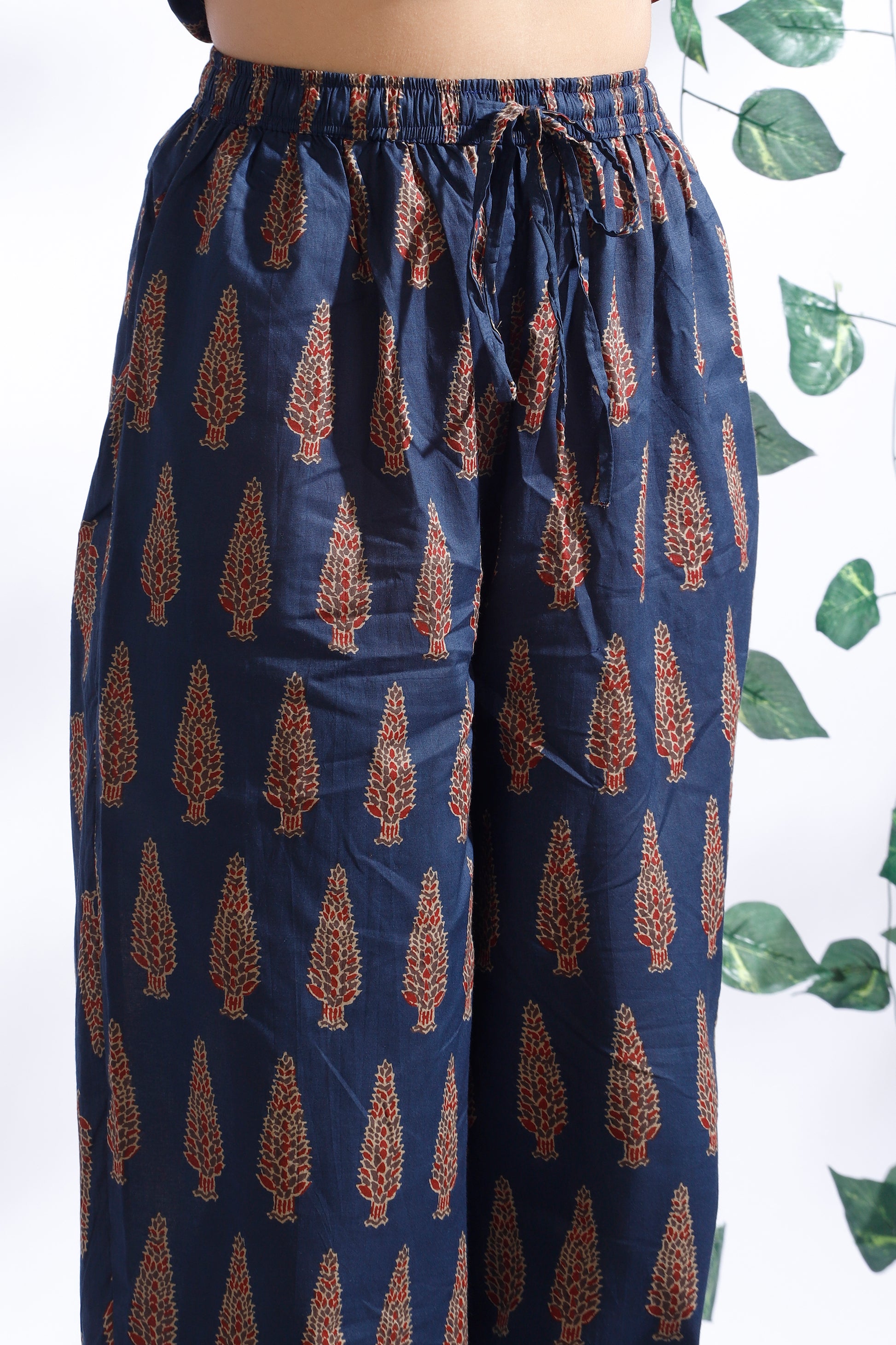 Navy blue pants with brown geometric pattern on a white background