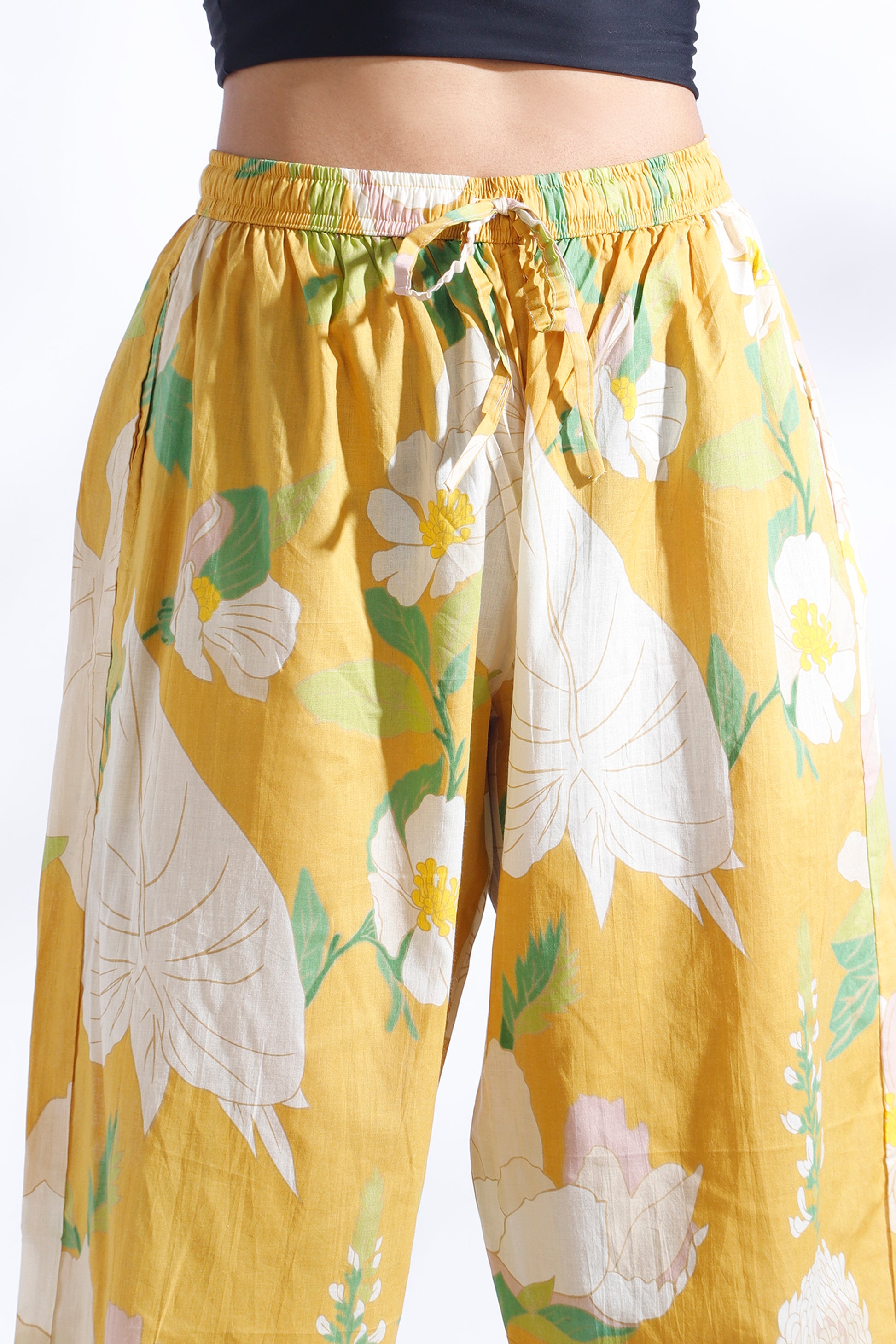 Yellow floral pants with a white background