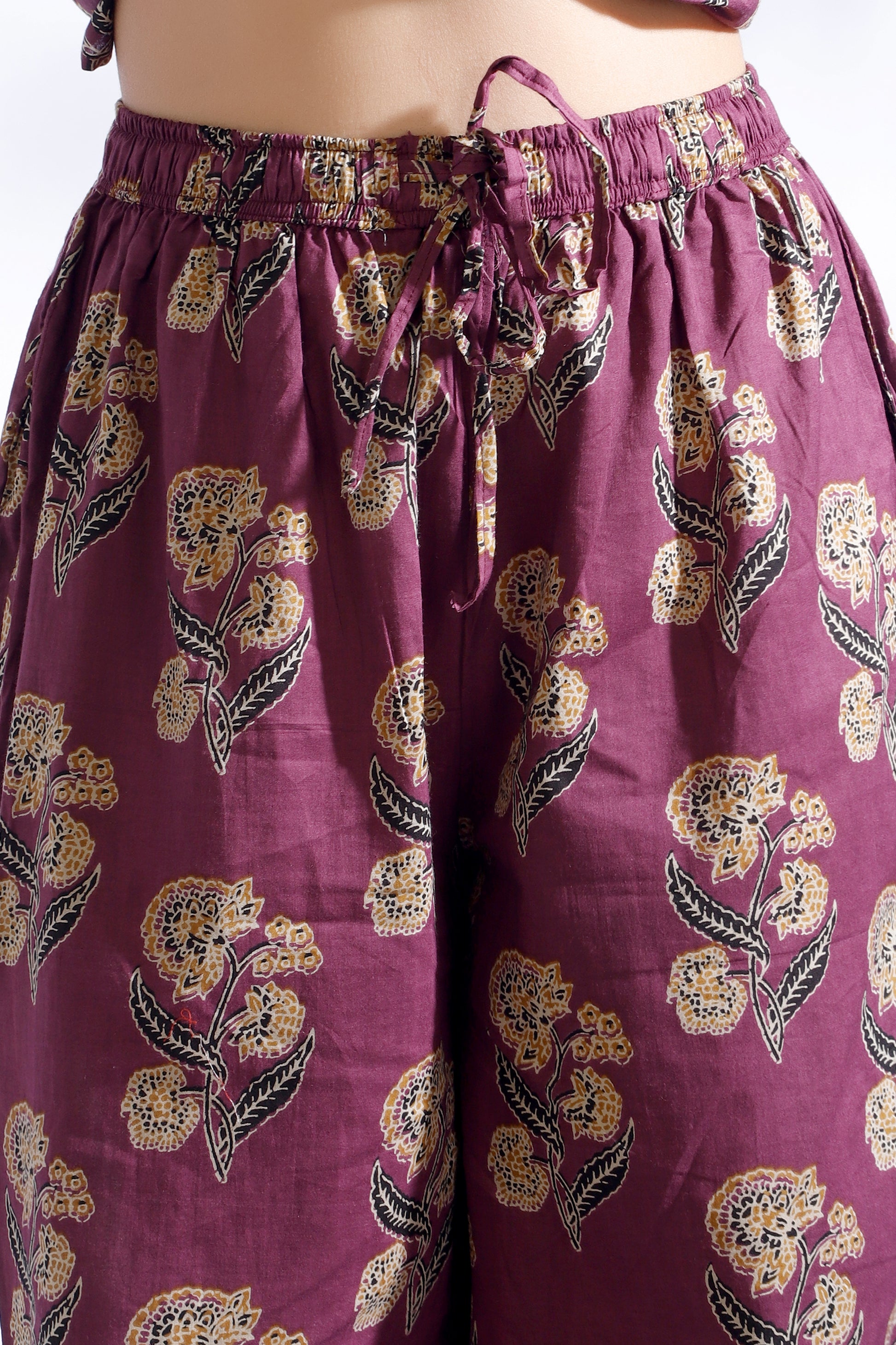 Purple floral-patterned pants on a white background