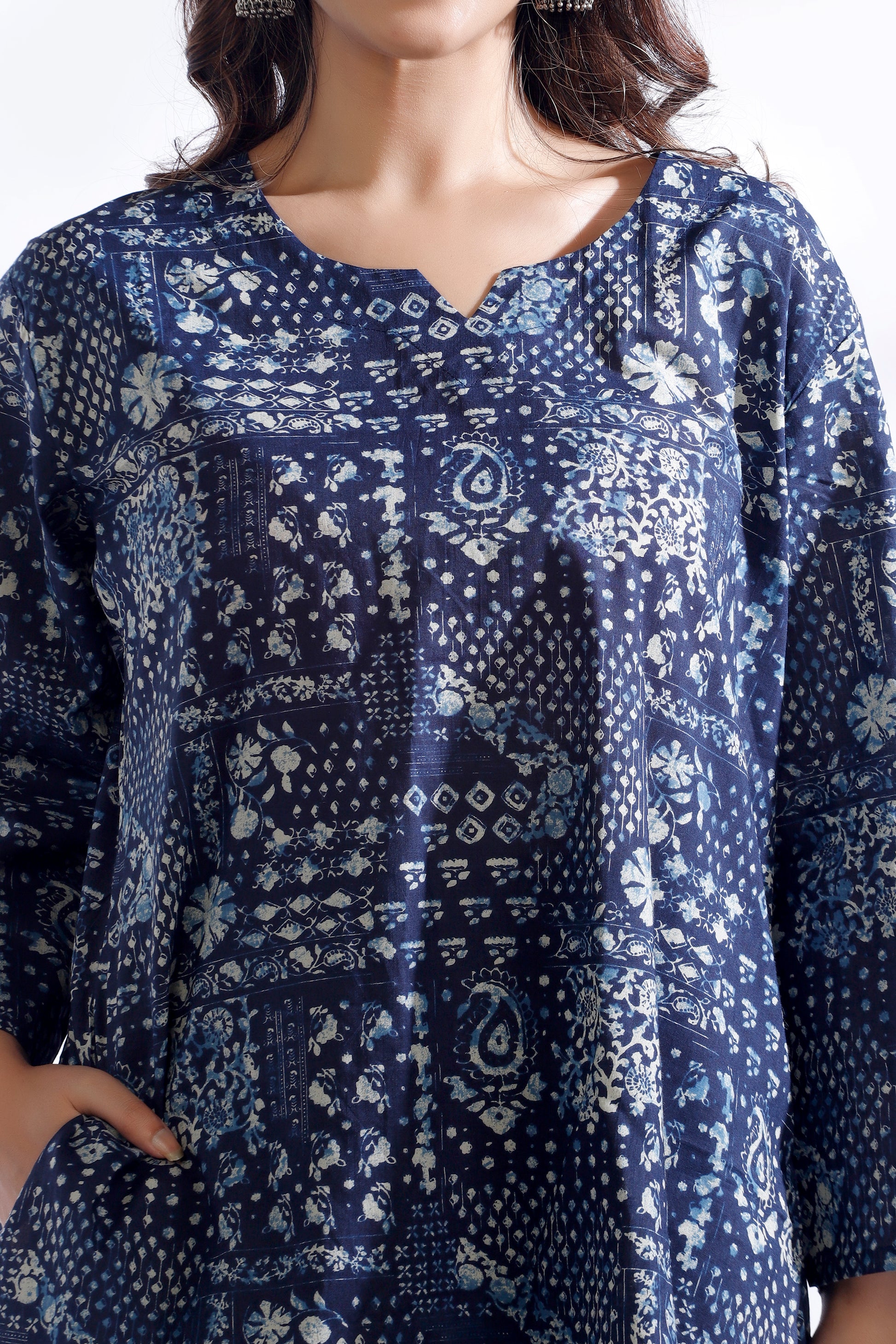 Blue patterned shirt worn by a person on a white background