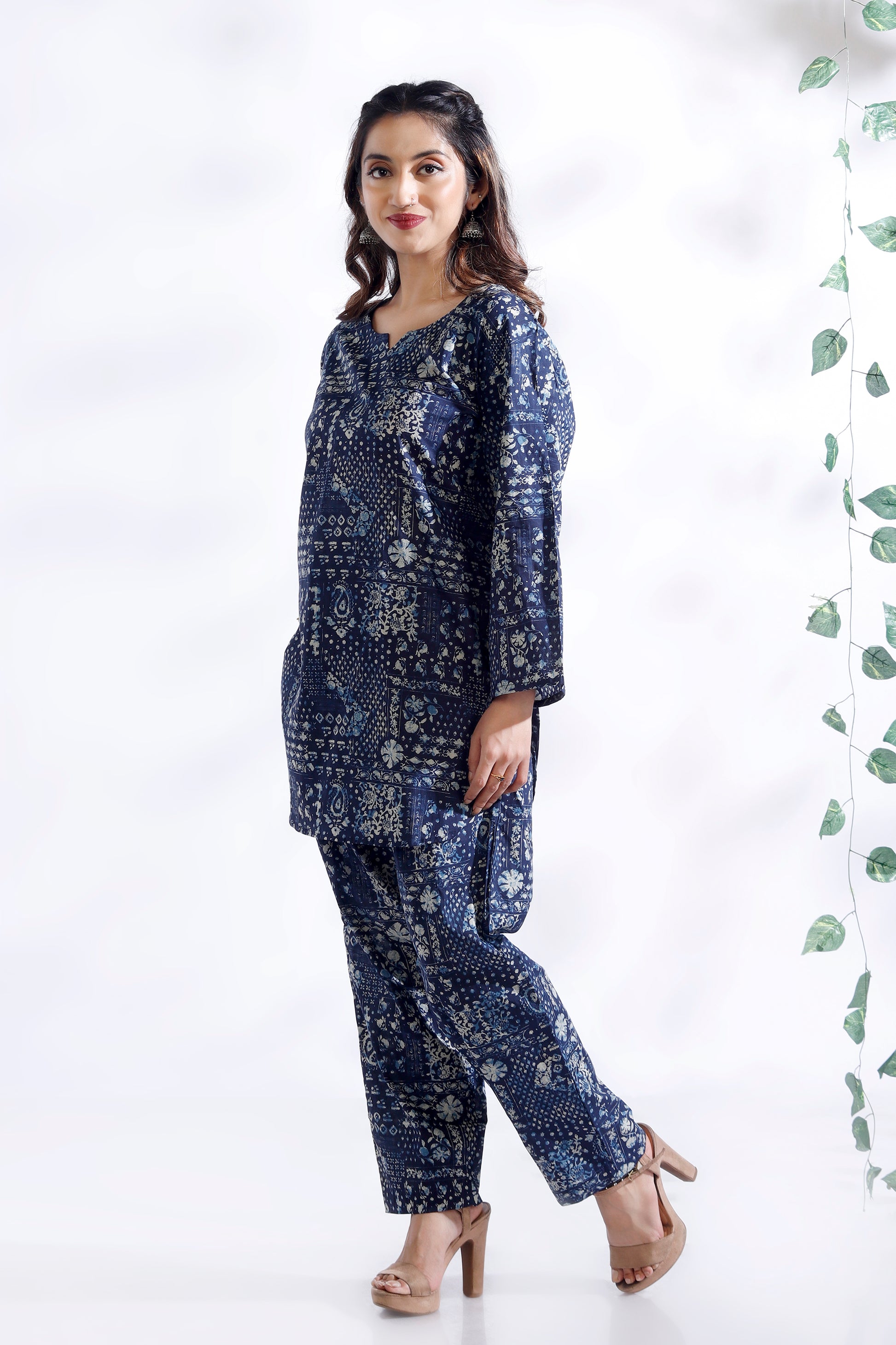 Woman wearing a blue floral outfit on a white background