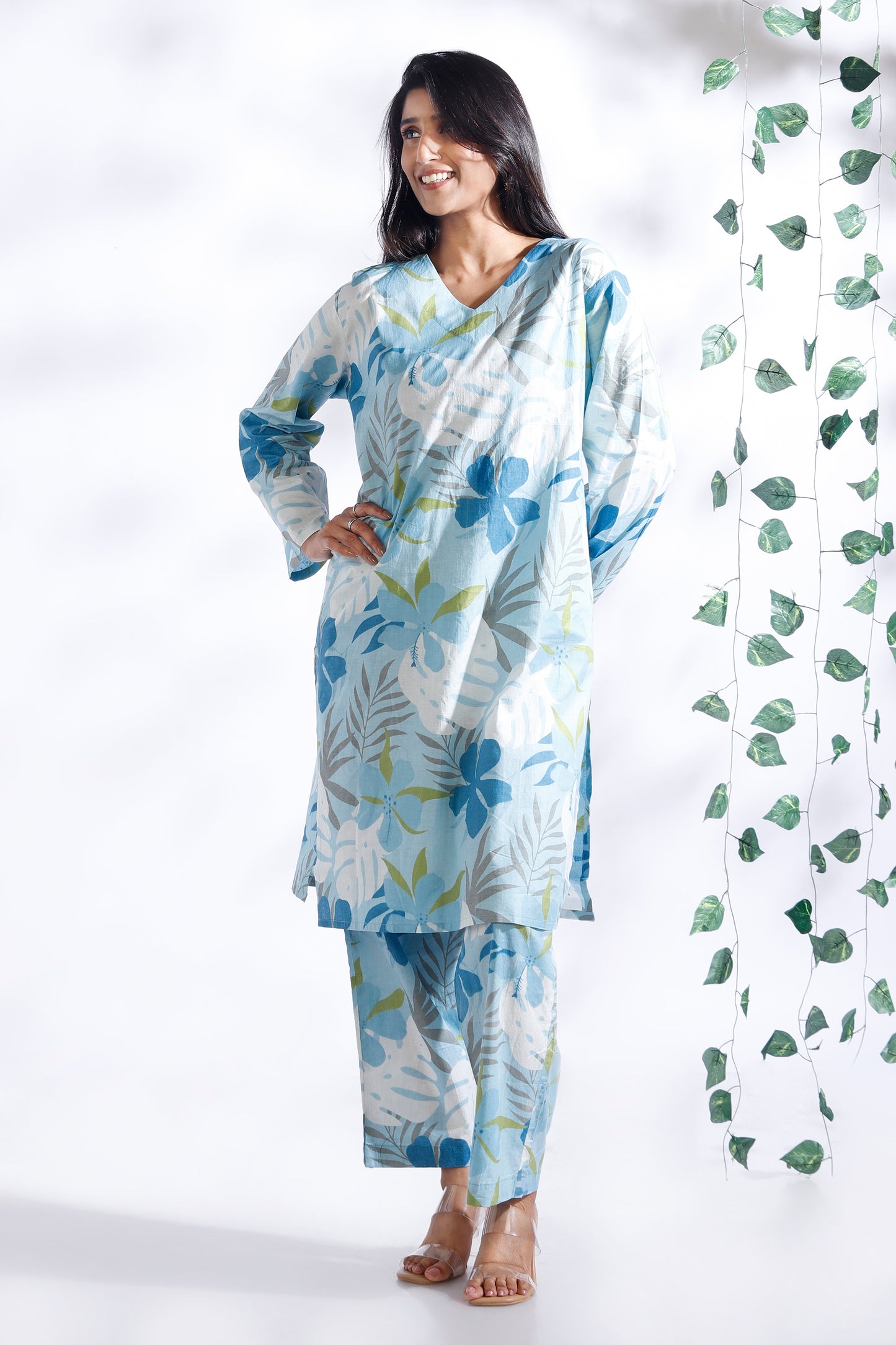 Woman wearing a floral outfit with a white background