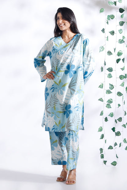Woman wearing a floral outfit with a white background