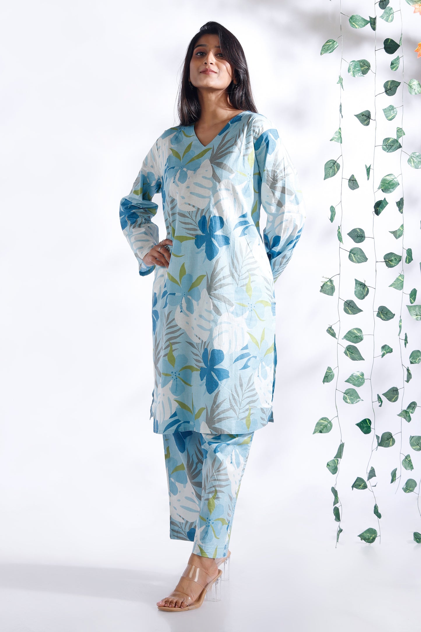 Woman wearing a blue floral outfit with a white background