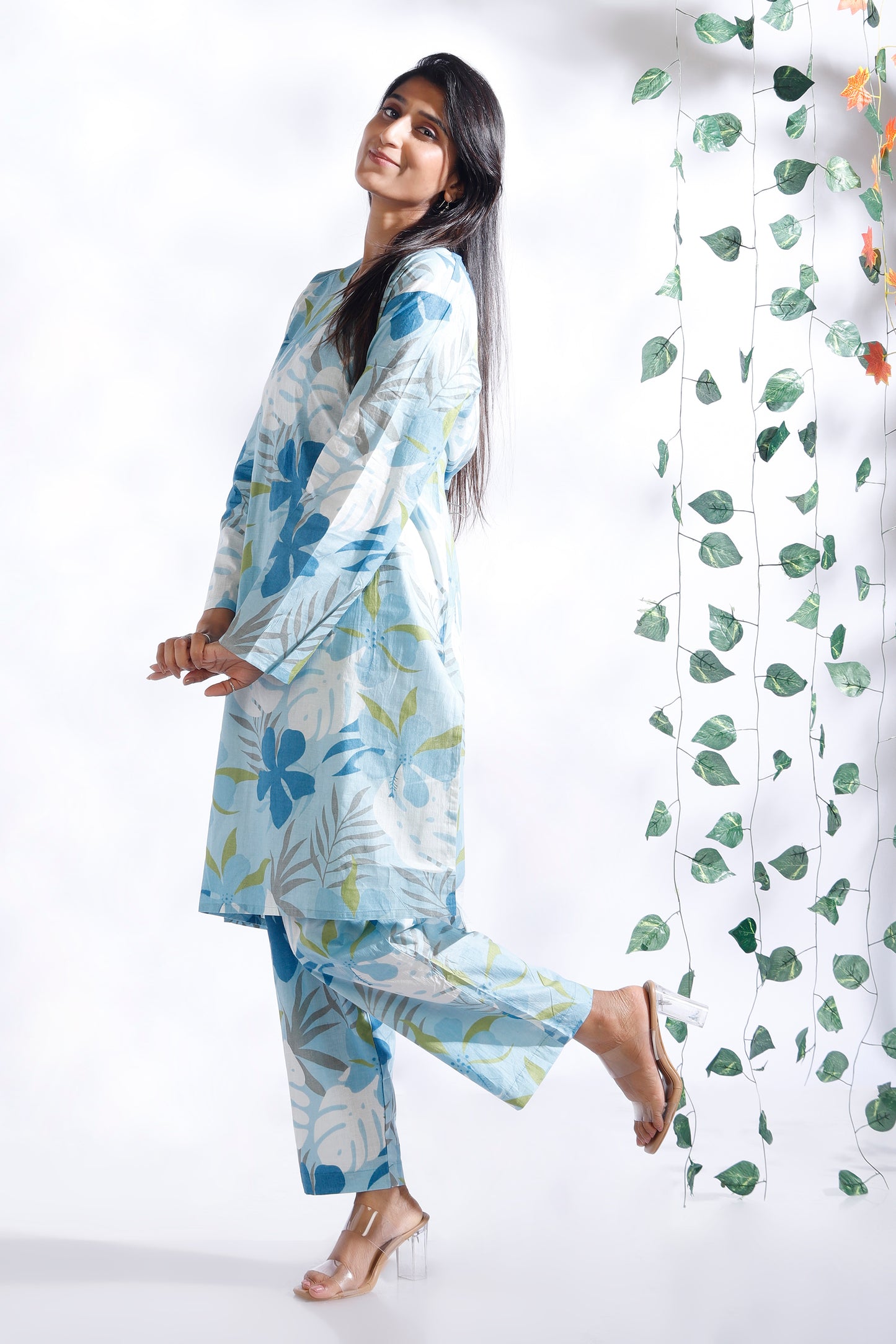 Woman wearing a floral outfit with a white background